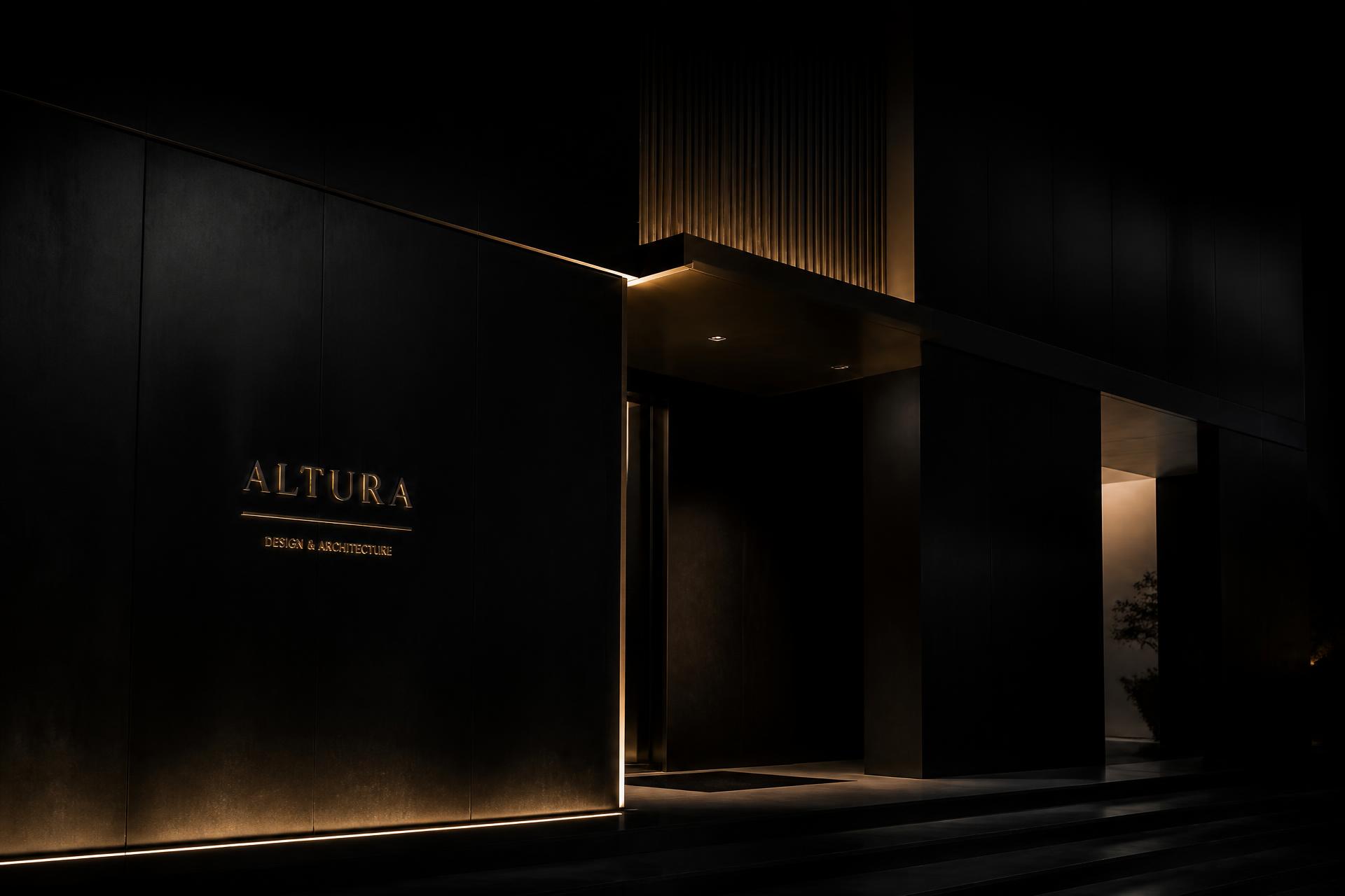 Dark architectural facade lit with warm champagne light
